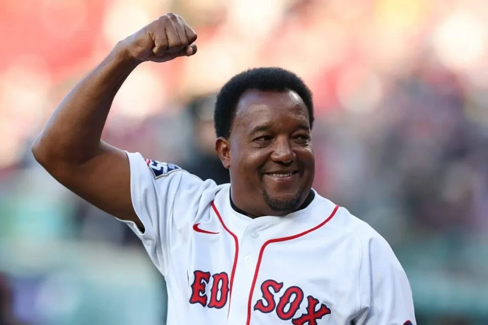 Pedro Martínez raises his right arm at Fenway Park.